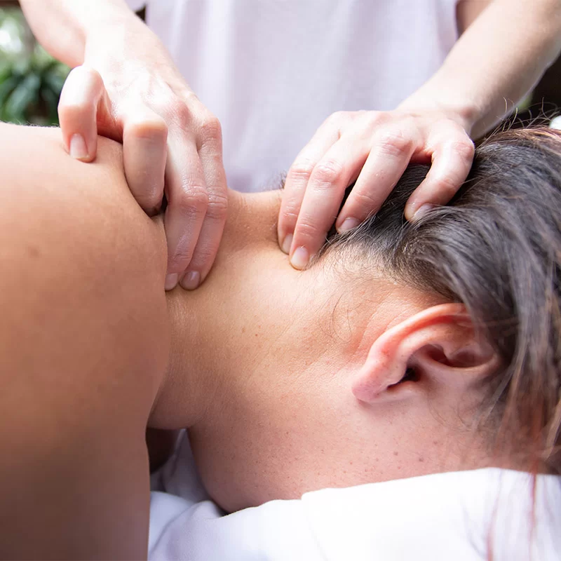 A woman receiving a neck massage at a Broken Bow cabin.