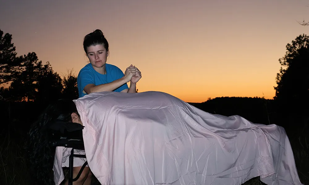 Mindi massaging a client at sunset