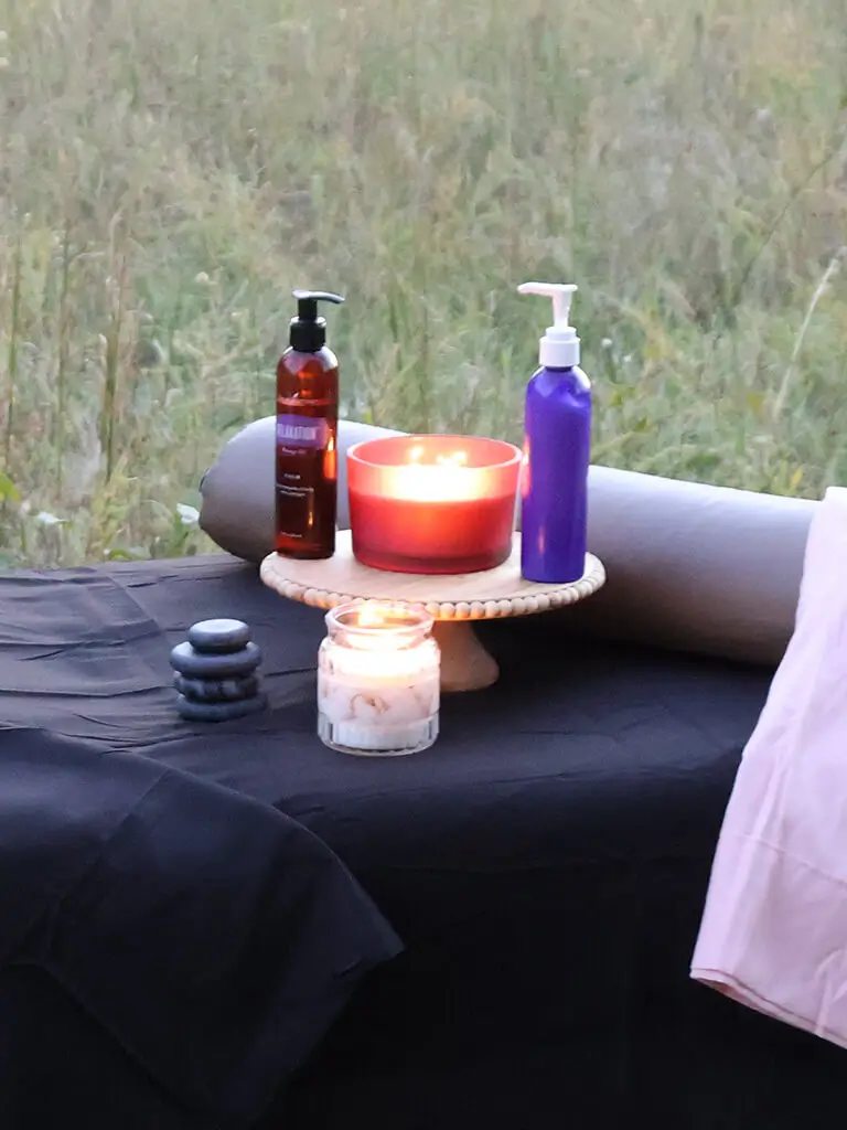 Lotions and candles on a massage table. 