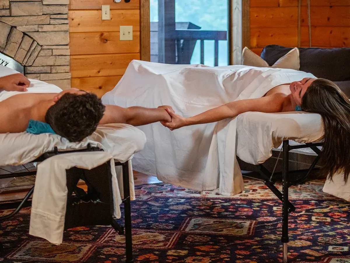 couples-mobile-massage A couple holding hands during a couples massage