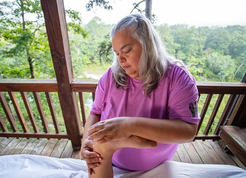 A massage therapist massaging a foot 