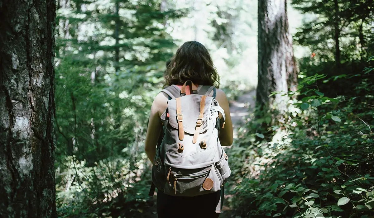 A woman hiking through a forest