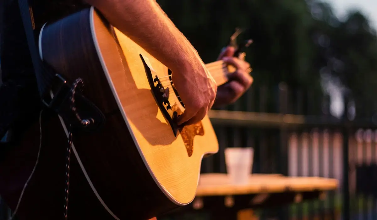 Someone playing acoustic guitar