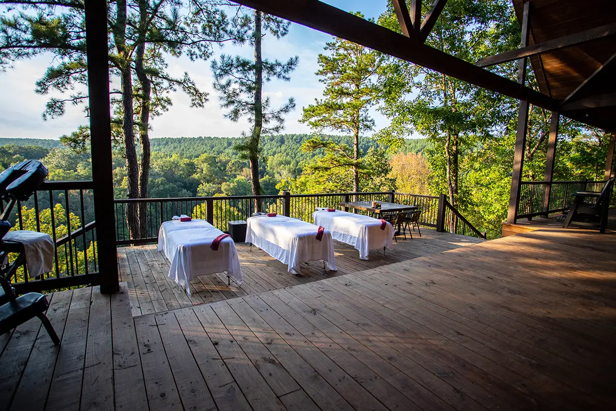 Three massage tables on a deck at a Broken Bow cabin