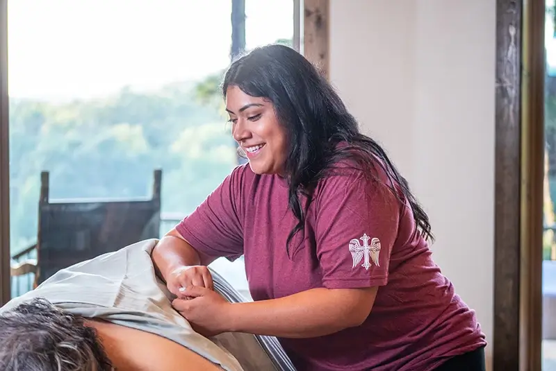 Who Benefits From Massages Massage therapist massaging client's back