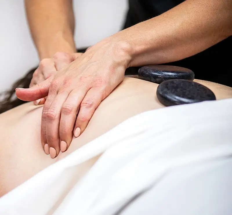 Customized Hot Stone Experience Woman getting a hot stone massage